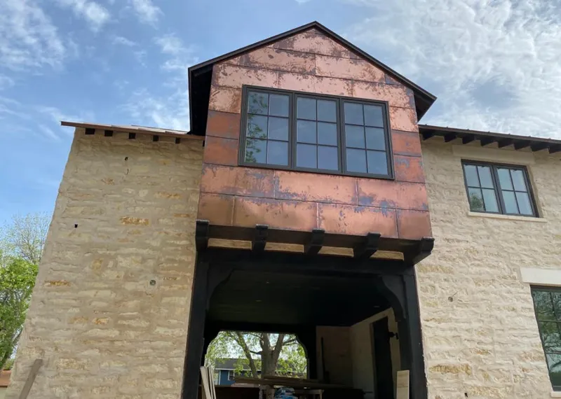 Copper metal panel facade on a stone building for Skylight Installation in Virginia Beach