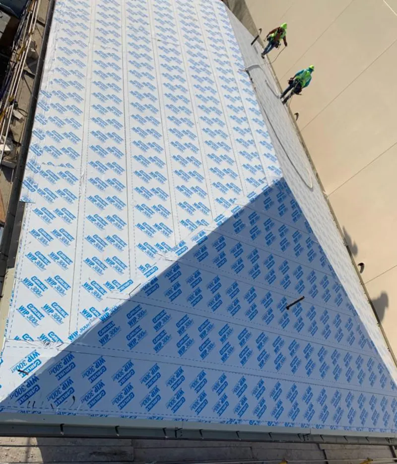 Professional roofers installing underlayment on a metal roof in Virginia Beach